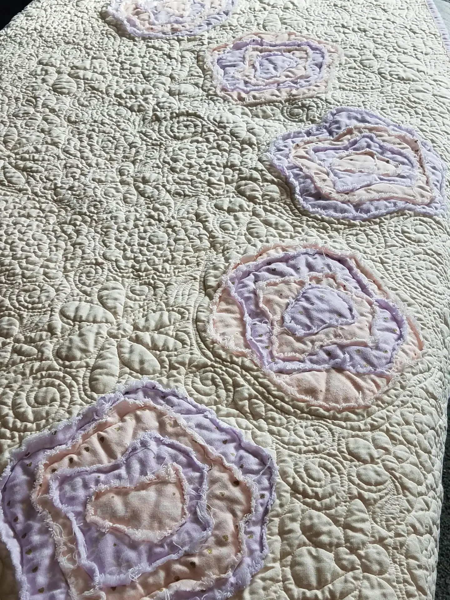 Free motion longarm quilting by Spencer Hatman in upstate New York, featuring precision stitching on one of Spencer's quilts