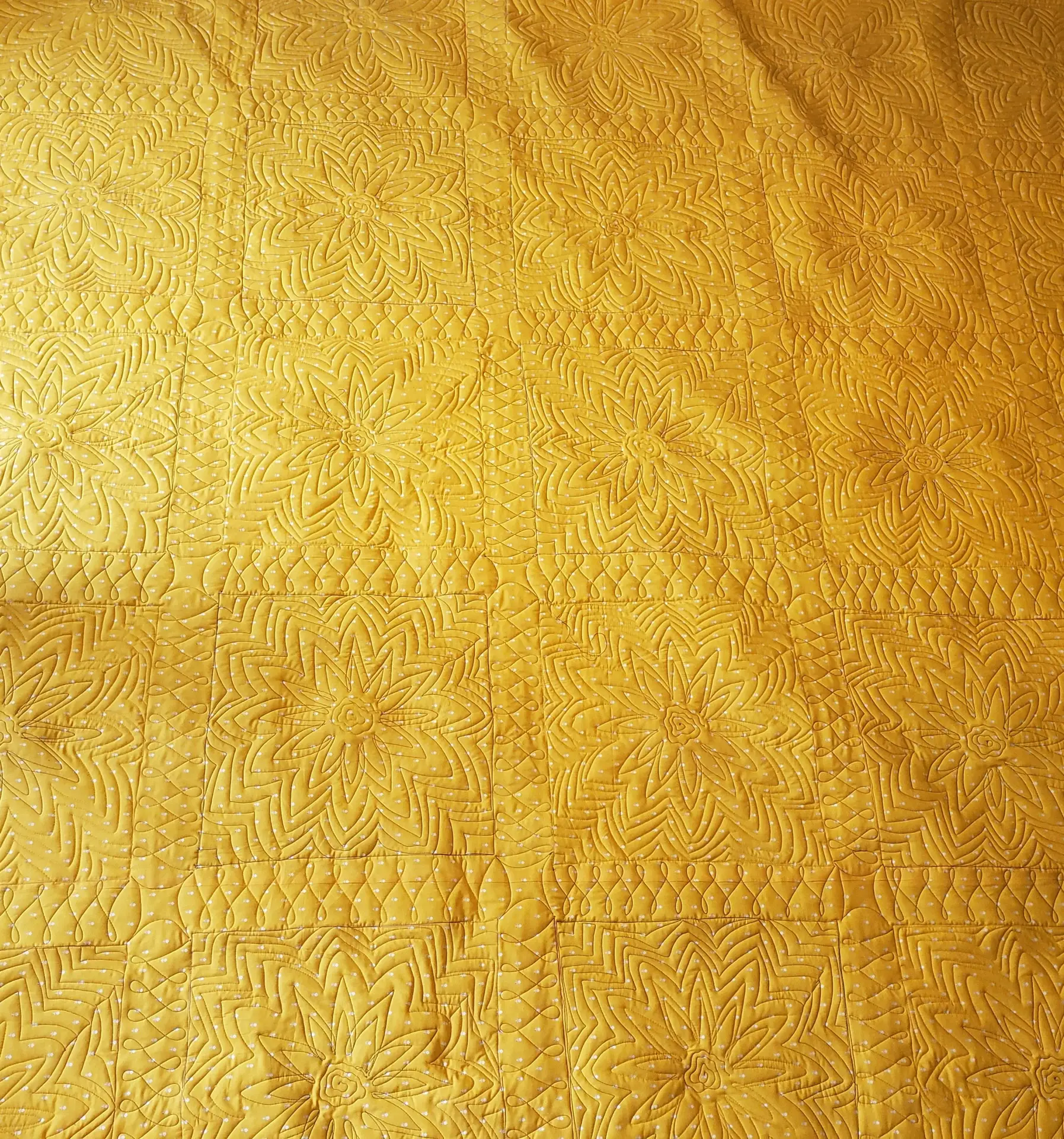 Free motion longarm quilting by Spencer Hatman in upstate New York, featuring precision stitching on one of Spencer's quilts