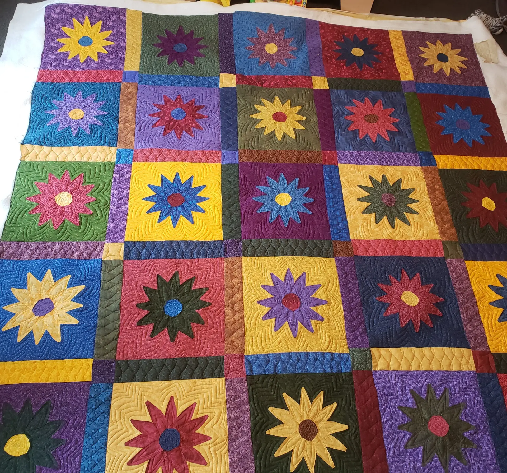 Free motion longarm quilting by Spencer Hatman in upstate New York, featuring precision stitching on one of Spencer's quilts