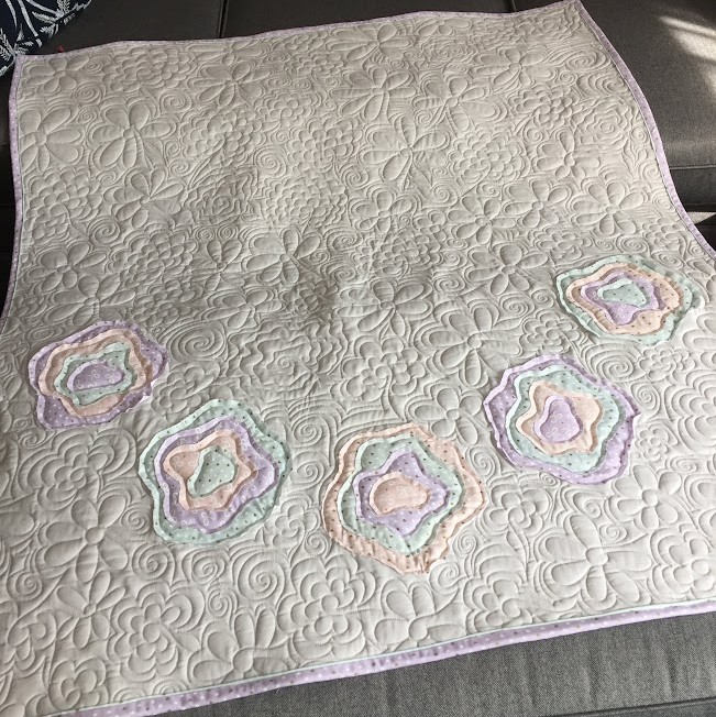 Free motion longarm quilting by Spencer Hatman in upstate New York, featuring precision stitching on one of Spencer's quilts